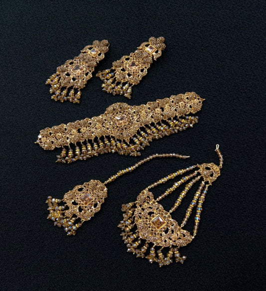 Gold Jewelry Pieces Including Earrings And a Hair Accessory